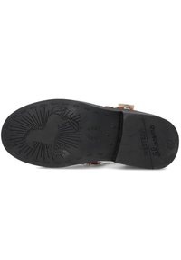 Black rubber shoe sole with a horseshoe pattern, featuring a silhouette of a horse and stars, marked with "Western," and size "27."