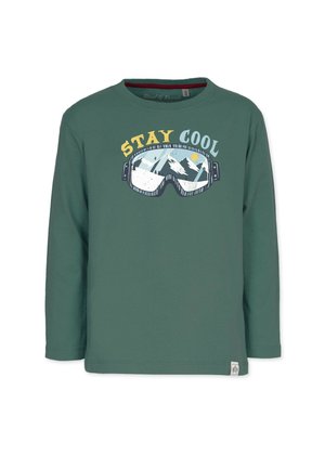 Green long-sleeve shirt with ski goggles graphic showing snow-covered mountains and sun, with text "STAY COOL" above the goggles.