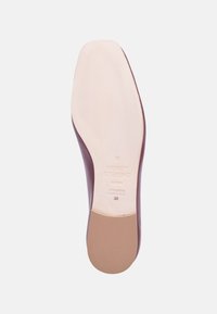 Leather shoe outsole featuring a smooth light beige surface, with a purple edge. Imprint of brand name and details on the bottom. Size 38.