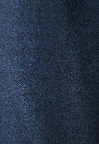 Dark blue textured fabric with a slightly rough and fuzzy surface, showing fine fibers and subtle color variations.