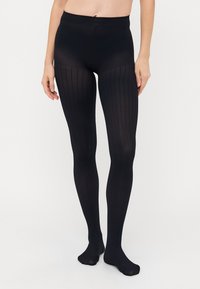 Schwarze blickdichte Strumpfhosen mit vertikalem Rippmuster, nahtlosem Bund und glatter Textur, die sich eng an den Beinen anschmiegen.