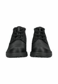 Stivali alla caviglia in pelle nera con una superficie liscia, punta rotonda e sei occhielli per i lacci. Presentano una suola in gomma robusta con battistrada.