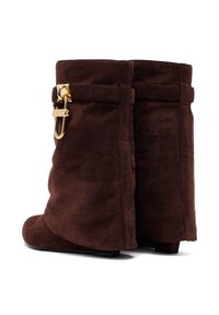 Brown suede ankle boots with a slouchy design, featuring a gold-tone hardware accent and a rounded toe. Flat sole for stability.