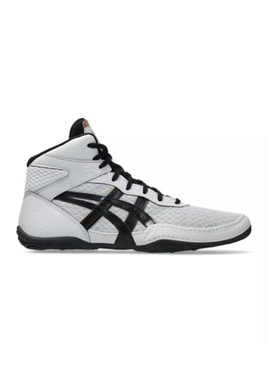 Scarpa sportiva alta bianca e nera con tomaia in mesh, lacci neri e suola nera, mostrata di profilo su sfondo bianco.