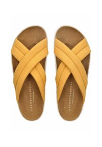 Žluté semišové sklápěcí sandály s překříženými popruhy, korkovou stélkou a bílou gumovou podrážkou, které se vyznačují plochým designem a měkkou texturou.