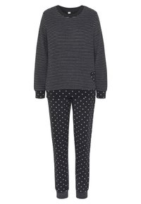 Black long-sleeve top with thin white stripes paired with black pants featuring small white heart patterns and cuffed ankles.