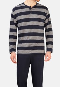 Langärmliges Hemd mit navy- und grauen Horizontalstreifen, einem Henley-Ausschnitt mit zwei Knöpfen und einer Brusttasche. Aus Baumwollmaterial.