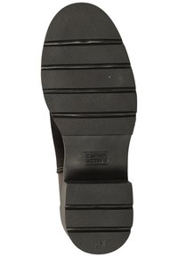 Black rubber shoe sole with horizontal grooves and a Camel Active logo. Features textured surface and a size marking of 37.