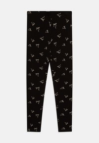 Leggings noirs avec un motif répétitif de nœuds de couleur claire, fabriqués dans un tissu doux et extensible, avec une coupe ajustée standard.