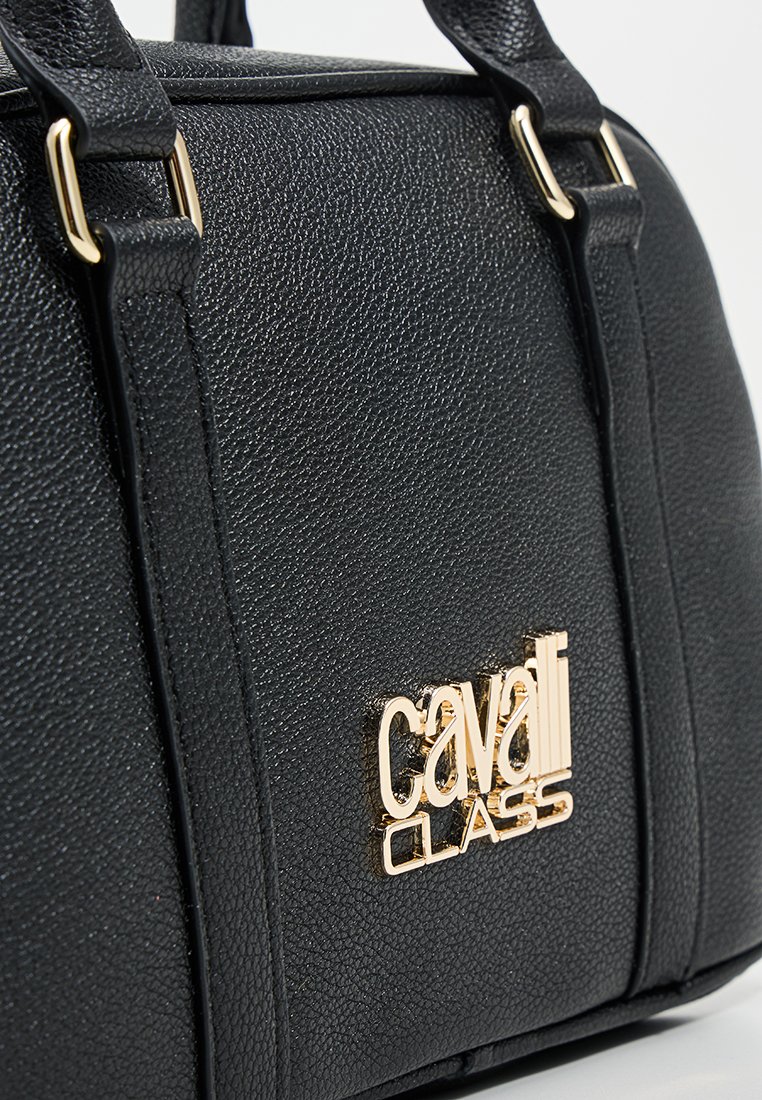 Sac à main noir en simili cuir texturé avec quincaillerie en métal doré. Dispose d'une plaque logo et de poignées courtes et robustes.