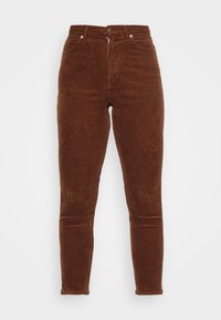 Hnědé námořnické kalhoty s vysokým pasem, slim fit a svislým ribbovaným vzorem. Obsahují přední kapsy a stříbrné kovové doplňky.