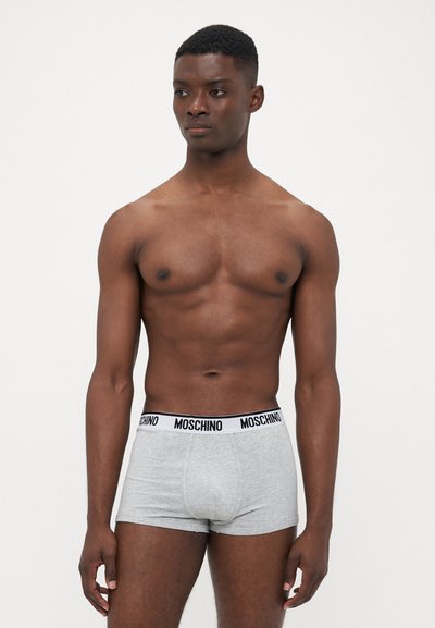 Gray boxer briefs with a white waistband featuring black "MOSCHINO" text. Fabric appears soft and stretchy. The design is minimalist and fitted.