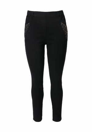 Pantalon noir slim avec taille élastique et poches latérales décorées de petits clous brillants.