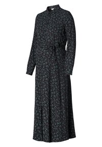 Robe midi noire à manches longues avec motif de feuilles vertes, col montant, devant boutonné et ceinture à nouer à la taille.