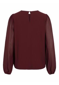 Top bordeaux con corpo in tessuto solido e maniche a sbuffo trasparenti. Presenta un'apertura a forma di chiave sul retro e polsini arricciati alle maniche.