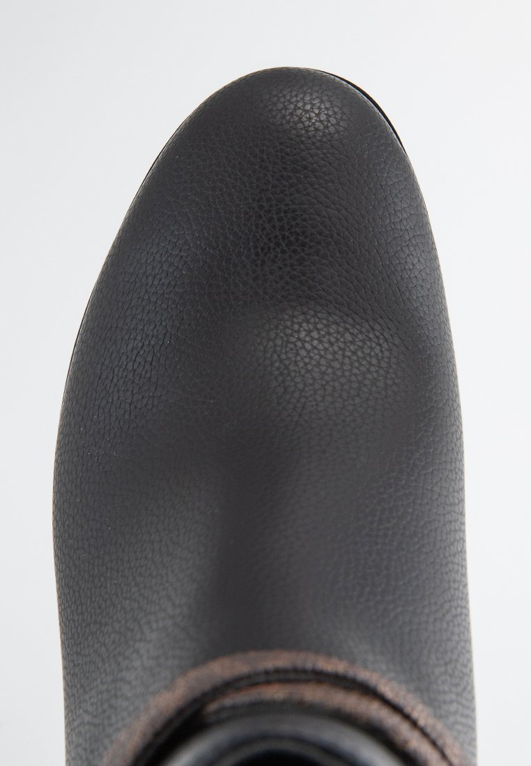 Stivale in pelle nera, superficie testurizzata, punta arrotondata, tacco basso, con un sottile accento marrone alla base. Zoom sui dettagli del materiale.