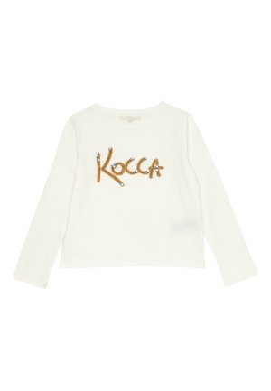 T-shirt bianca a maniche lunghe realizzata in tessuto morbido, con la parola "Kocca" in paillettes e perline dorate sul davanti.