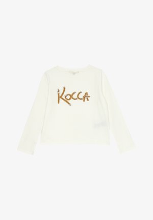 T-shirt bianca a maniche lunghe realizzata in tessuto morbido, con la parola "Kocca" in paillettes e perline dorate sul davanti.