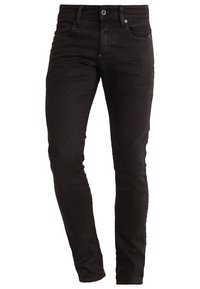 Jeans skinny de denim negro con una textura suave, que cuentan con cierre de botón y cremallera, cinco bolsillos y trabillas para cinturón.