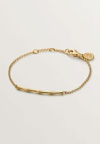 Pulsera de oro con una delicada cadena y un diseño central inspirado en el bambú. Cierre de broche con un pequeño detalle de charm redondo.