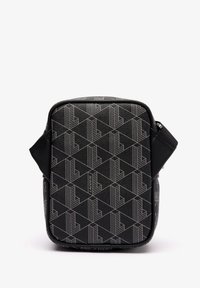 Black textured bag featuring a geometric pattern in grey. Zip closure and adjustable strap. Front has logo detailing. Rectangular shape.