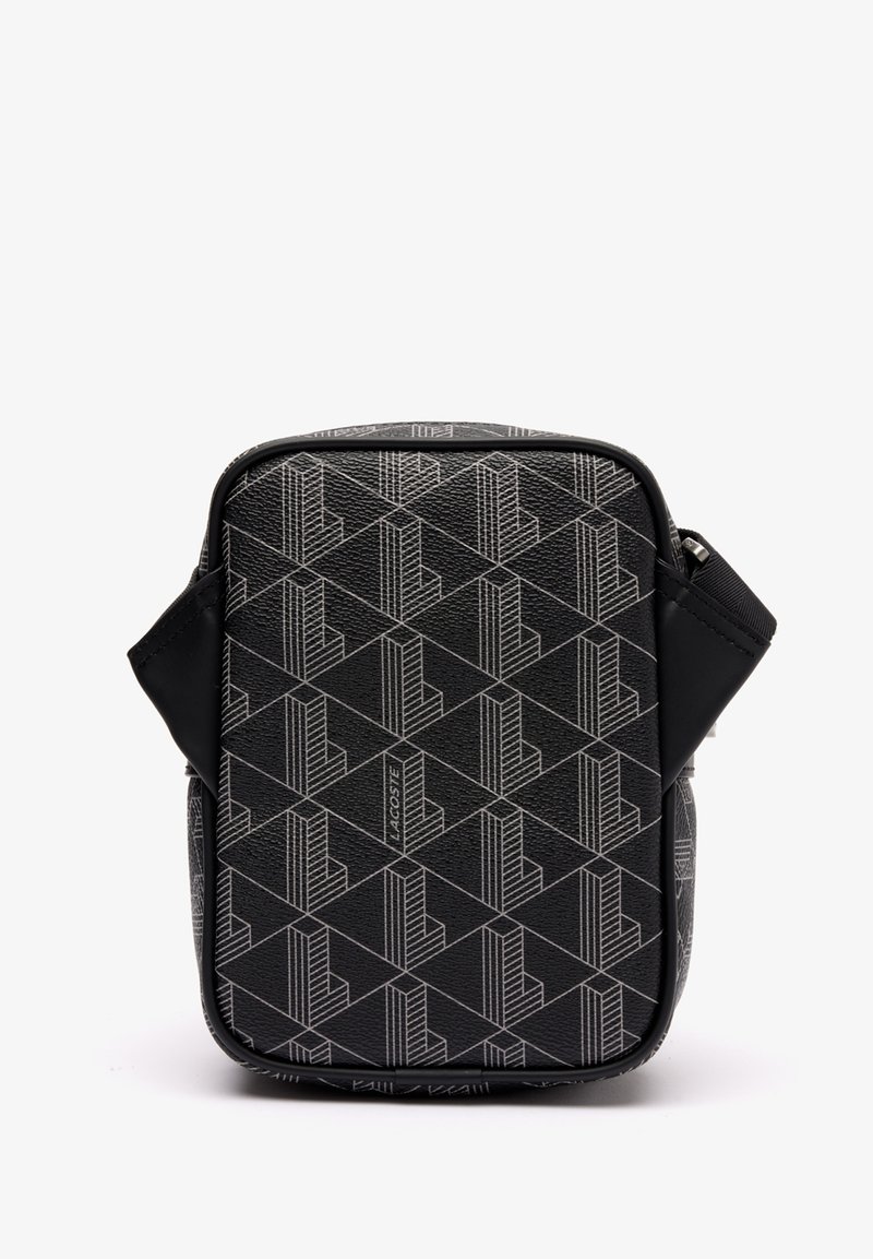 Black textured bag featuring a geometric pattern in grey. Zip closure and adjustable strap. Front has logo detailing. Rectangular shape.