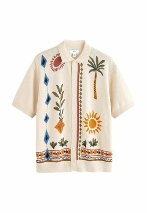 Īsi piedurkņu krēmkrāsas jaka ar krāsainu ziedu un ģeometrisku izšuvumu, ar pogu aizdari un klasisku apkakli.