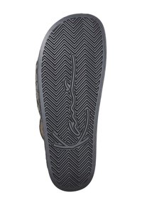Black rubber shoe sole with a herringbone pattern and a smooth logo design in the center. Durable material with textured grip for traction.