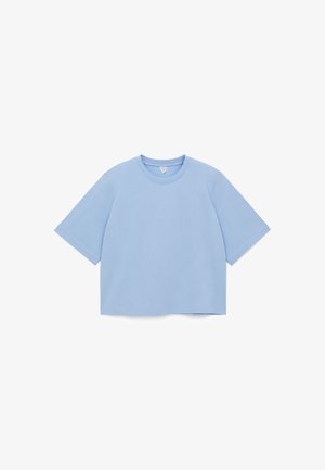 Light blue oversized t-shirt in soft cotton material, featuring a round neckline and short sleeves with a straight hem.