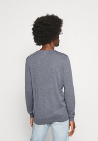 Blue-gray long-sleeve knit sweater with a round neckline and ribbed cuffs. Made of soft fabric, featuring a relaxed fit and side slits.