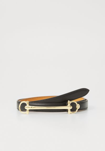 Black leather belt with a textured finish, featuring a gold-tone metal buckle and loop accents. Interior lined with contrasting tan leather.