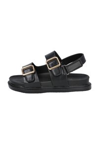 Sandalias de cuero negro con dos correas, con hebillas doradas. Suela plana y diseño de parte trasera abierta para facilitar su uso. Textura suave.
