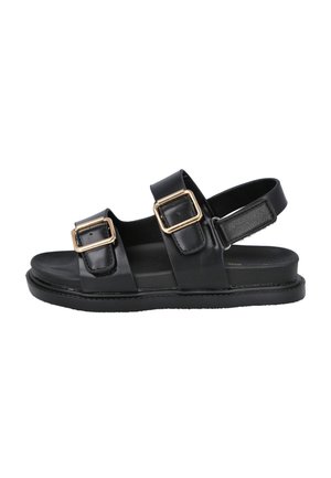 Sandalias de cuero negro con dos correas, con hebillas doradas. Suela plana y diseño de parte trasera abierta para facilitar su uso. Textura suave.
