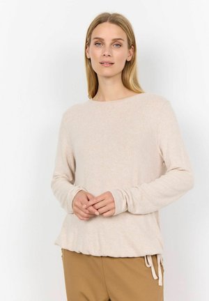Long-sleeve beige sweater with a soft texture and a round neckline. Features a relaxed fit and side ties at the hem.