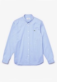 Camicia a maniche lunghe blu e bianca a scacchi con colletto abbottonato, sfoggia un piccolo logo verde sul petto. Tessuto in cotone, texture liscia.