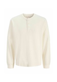 Langermet henley-skjorte i kremfarge laget av ribbet stoff, med rund hals og bryststykke med tre knapper.