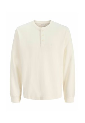 Langærmet henley-trøje i cremefarvet ribbet stof med rund halsudskæring og treknapslukning.