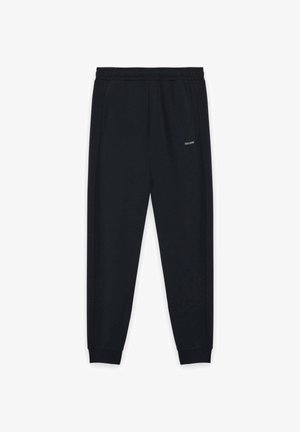 Pantaloni jogger neri a gamba affusolata con vita e polsini elastici, caratterizzati dal piccolo logo "Lyle & Scott" sulla coscia destra.