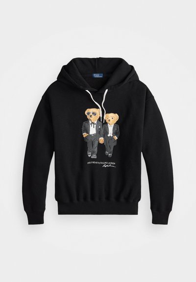 Mustast kapuutsiga sviiteril on graafika kahe karu kujutisest smoky kampsunites, kellest üks kannab prille. Valmistatud puuvillast, varustatud nööriga kapuutsiga ja soonikuga mansettidega.