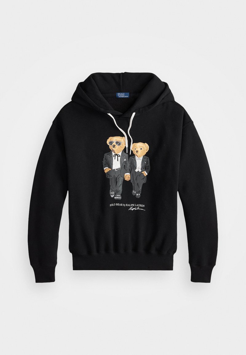 Den sorte hættetrøje har et grafisk design af to bjørne i tuxedoer, hvoraf den ene bærer solbriller. Den er lavet af bomuld og har en hætte med snor samt ribbede manchetter.