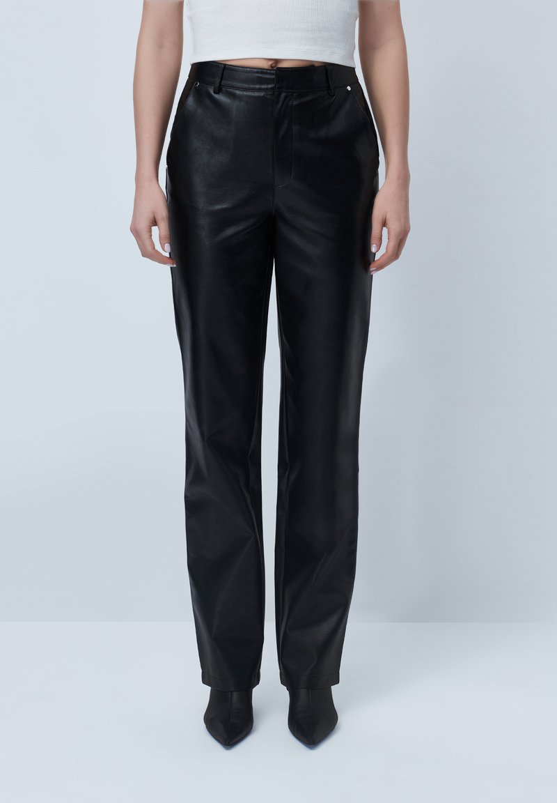 Black leather straight-leg trousers with a smooth texture and a mid-rise waist, paired with pointed black heels.