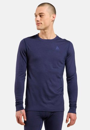 Navy long-sleeve performance shirt, lightweight fabric, round neckline, fitted design, featuring a subtle logo on the upper chest.