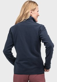 Marineblaue Fleecejacke mit hochgeschlossenem Kragen, langen Ärmeln und glatter Textur, die für Wärme und Komfort konzipiert ist. Ohne sichtbare Markenkennzeichnung.