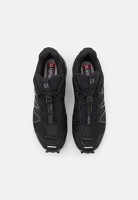 Pair of black Salomon Speedcross trail running shoes with quick-lace system and Ortholite insoles, viewed from above on white background.