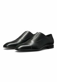 Black leather dress shoes with pointed toes, sleek design, stitched detailing, and a low heel. Lace-up closure with six eyelets.