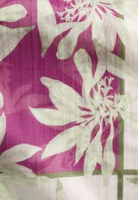 Floral fabric with large green and white flowers on a vibrant purple background, featuring subtle texture and a faint grid pattern.