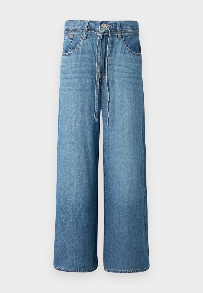 Wijde spijkerbroek in lichtblauwe denim. Voorzien van een knoopsluiting met een trekkoord in de taille, vijf zakken en een licht vervaagde afwerking.