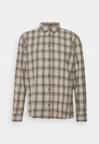 Chemise à boutons beige avec motif à carreaux marron. Tissu doux, manches longues, col classique et fermeture à boutons sur le devant.