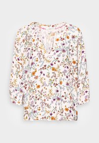 Blumenbluse mit V-Ausschnitt, Dreiviertelärmeln und einem hellen Stoff mit mehrfarbigen Blumen- und Blattmustern.