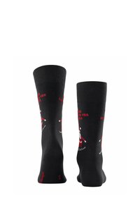 Czarne bawełniane skarpetki z prążkowanymi szczytami, z motywem Świętego Mikołaja na nartach i czerwonym napisem "Wracam do domu na Święta".